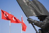 Detail of harbourside war memorial and Turkish flags. Fethiyeformerly Telmessosformerly modern Greek MakriAegeanTurkish rivieraLycianLyciastatuesculpturecommemorativecommemorate Destination...