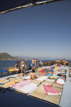 Tourists on sun deck of pleasure boat day trip. Fethiyeformerly Telmessosformerly modern Greek MakriAegeanTurkish rivieraLycianLyciaSummerseasonsunsunbatheholidaycruiseGuletseablue sky...