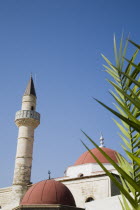 Defterdar Mosque on Plateia Eleftherias Square at centre of Kos Town.  Minaret of Ottoman style as the island was once Ottoman territory.Greek Islands Resort Summer Clear Blue Sky early season AegeanDestination Destinations Ellada European Greek Southern Europe Center Religious