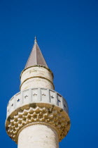 Defterdar Mosque on the town square  Plateia Eleftherias.  Top of minaret against blue sky with passing plane leaving white vapour trail. The island was formerly an Ottoman territory.Destination Dest...