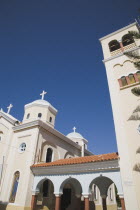 Agia Paraskevi Greek Orthodox Church.  Cream and white facade with colonnaded entrance with red tiled roof.  Greek IslandsAegeanMediterraneanKossummerseasonholidayDestination Destinations Ella...