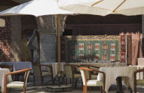 Outside tables of cafe hung with Turkish carpets.TurkishAegeancoastresortSummersunshineearly Summer seasonholidaydestinationdestinations ElladaEuropeanSouthern Europe Bar Bistro Destinatio...