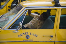 Taxi driver asleep in his cab.TurkishAegeancoastresortSummersunshineearly Summer seasonholidaydestinationdestinations ElladaEuropeanSouthern Europe Destination Destinations Middle East One...