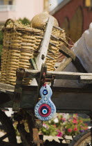 Nazar Boncugu or boncuk bead used to ward off the Evil Eye hanging from traditional cart in early summer sunshine. formerly Greek Physkos in CariaTurkish RivieracoastcoastalOttomanresortholiday...