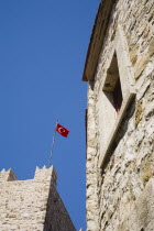 Marmaris Castle crenellated walls with Turkish flag flying against bright blue sky.formerly Greek Physkos in Caria once host to AlexandeTurkish RivieracoastcoastalOttomanholidayresortSummersu...