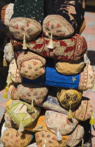 Ottoman style cushions and textiles displayed for sale to tourists in summer sunformerly Greek Physkos in Caria once host to AlexandeTurkish RivieracoastcoastalOttomanholidayresortsunshineClo...