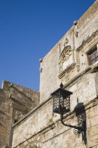 Rhodes Old Town.  Detail of Old Town Medieval walls against early summer blue sky in UNESCO World Heritage Site with decorative lantern casting shadow against stone.Aegeancoastcoastalformer Ottoman territorylocation for Guns of NavaroneRodiSunshineEarly Summer seasonholidaytripDestination Destinations Ellada European Greek Southern Europe History Historic Rodos