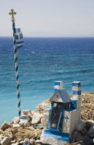 Memorial shrine and cross on headland above Ixia beach resort looking East towards Rhodes Town with clear  aquamarine sea beyond. Aegeancoastcoastalformer Ottoman territorylocation for Guns of Na...