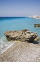 Deserted beach with rocks and clear  shallow  aquamarine water at Ixia beach resort looking East towards Rhodes Town.Aegeancoastcoastalformer Ottoman territorylocation for Guns of NavaroneRodiS...