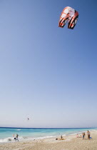 Kite Surfing above Ixia beach resort looking East towards Rhodes Town.  Tourists and water sports staff looking on with clear  aquamarine sea beyond.Aegeancoastcoastalformer Ottoman territoryloca...