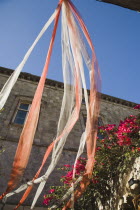Rhodes Town.  Red and white wedding ribbons hung in medieval courtyard in the Old Town.AegeancoastcoastalFormer Ottoman territoryearlySummer seasonlocation of Guns of Navaronepackageholiday...