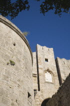 Stone walls and tower of Amboise Gate entrance to the Old Town against cloudless blue sky.GreekAegeanCoast - CoastalRodiPackage holidaydestination destinations resortsun sunshine sunnyDestinat...