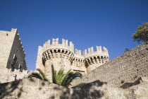 Fortified walls and crenellated towers of Amboise Gate entrance to the Old Town against cloudless blue sky.GreekAegeanCoast - CoastalRodiPackage holidaydestination destinations resortsun sunshi...