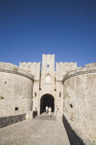 Tourists approaching arched entrance of Amboise Gate entrance to Old Town.GreekAegeanCoast - CoastalRodiPackage holidaydestination destinations resortsun sunshine sunnyDestinations Elladafort...