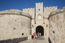 Tourists at arched entrance of Amboise Gate entrance to Old Town.GreekAegeanCoast - CoastalRodiPackage holidaydestination destinations resortsun sunshine sunnyDestinations Elladafortified for...