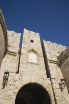 Fortified walls of Amboise Gate entrance to the Old Town against cloudless blue sky.GreekAegeanCoast - CoastalRodiPackage holidaydestination destinations resortsun sunshine sunnyDestinations E...