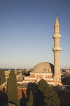 Minaret and domed roof of the nineteenth century Suleyman Mosque and skyline of the Old Town in afternoon sun.AegeanGreekByzantineRodilocation for Guns of Navaronecoast coastalsun sunshine sunn...