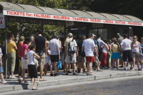 Crowds waiting at Bus stop in Rhodes Town for buses to Faliraki and south coast resorts popular with young British tourists.AegeanRodiseacoast coastalpackage holiday resortsun sunshine sunnyDes...