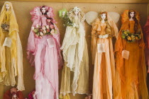 Lindos.  Display of brightly dressed dolls made locally in Lindos for sale in tourist handicrafts shop. AegeanGreekSummer seasonRodicoast coastalpackage holidaytrip destinationDestinations El...