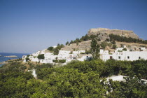 The Akropolis on rocky hilltop with whitewashed houses of Lindos spread out below.Greek IslandsAegeanRodiAcropolisArchaeologicalCitadelFortified fortificationcoast coastalsearesortholidayp...