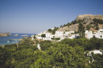 The Akropolis on rocky hilltop with whitewashed houses of Lindos spread out below.Greek IslandsAegeanRodiAcropolisArchaeologicalCitadelFortified fortificationcoast coastalsearesortholidayp...