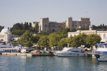 Rhodes Town.  Crenellated walls of the Old Town fortifications from the deck of an offshore boat.  UNESCO World Heritage Site.AegeanGreek IslandsRhodiMedievalcitadelfortifiedharbour portSummer...