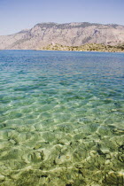 Clear  shallow  aquamarine water off Ag. Panormitis monastery in the bay on the South of the island.AegeanGreek IslandsSimiharbour Summerseacoast coastalresortholidaypackagetripDestination...