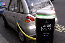 Westminster  Electric Car Juice Point where electric vehicles get their batteries charged. Silver citycar attached by yellow lead during charge.UKUnited KingdomGBGreat BritainEuropeEuropeanTran...