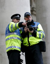 England  London  City  Threadneedle Street  Bank of England G20 Protests  April 2009. Police photographer taking pictures of the protesters.European UKUnited KingdomGBGreat BritainEuropeEuropean...