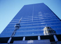 CANADA, Ontario,Toronto, The C.N. Tower reflected in Front Street glass fronted building.