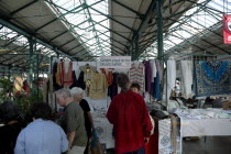 St Georges Market on a busy friday morning  busy with shoppers. Stall selling traditional Irish linen.Beal Feirste Eire European Irish Northern Northern Europe Republic Ireland Poblacht na hEireann C...