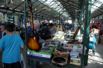 St Georges Market on a busy friday morning  busy with shoppers. Stall selling old records  music and musical instruments.Beal Feirste Eire European Irish Northern Northern Europe Republic Ireland Pob...