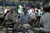 St Georges Market on a busy friday morning  busy with shoppers. Stall selling household Bric a Brac.Beal Feirste Eire European Irish Northern Northern Europe Republic Ireland Poblacht na hEireann Imm...