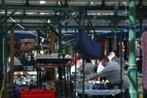 St Georges Market on a busy friday morning  busy with shoppers. Stall selling household Bric a Brac  including a model of the Titanic.Beal Feirste Eire European Irish Northern Northern Europe Republi...