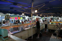 St Georges Market on a busy friday morning  busy with shoppers. Stalls selling various type of olives.Beal Feirste Eire European Irish Northern Northern Europe Republic Ireland Poblacht na hEireann O...