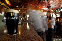 Great Victoria Street  The Crown Bar Liquor Saloon. Built in 1826 it features gas lamps and cosy snugs. Detail of a pint of Guinness stout on the bar.Beal Feirste Eire European Irish Northern Norther...