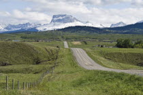 Ranch land in the foothills of Chief Mountain and the Rockies. Road going off into the distance.American Canadian North America Northern Blue Clouds Cloud Sky Scenic