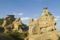 Sacred to the Blackfoot who believe the spirits of ancestors dwell among the wind-eroded rocks. Writing on rocks.American Canadian North America Northern Blue Scenic