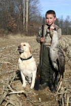 Tyler Stone  8 year old boy  Cooper  yellow labrador retreiver pet dog  goose hunting  boys first goose.American North America Northern United States of America Eight Immature