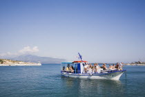 Pythagorio.  Day trippers on tour boat returning to harbour in late afternoon  early Summer season.AegeanGreek IslandsPythagorionSummerseacoast coastalresortholidaypackagetripDestination De...