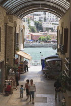 Kusadasi.  Covered shopping area framing view towards harbour.  A popular stopping point for Ephesus tours in early Summer.AegeanCoast CoastalSeaHolidayVacationResortport Destination Destinatio...