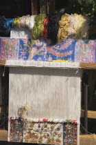 Kusadasi.  Loom with part woven textile and coils of coloured silks displayed at Club Caravanserail built by vizier Okuz Mehmed Pasha in 1618 for the Ottoman Sea trade.  Restored in 1966  now used as...