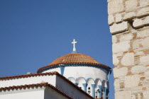 Pythagorio.  Metamorfosis Sotiros Greek orthodox Church.  Part view of white painted circular tower with blue painted detail and red tiled roof.AegeanGreek IslandsPithagorion Pythagorioncoast coas...