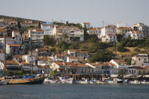 Pythagorio.  View across bay towards waterfront and houses on hillside behind with line of moored yachts and day trip cruise boat.North Eastern AegeanGreek IslandsPithagorion Pythagorioncoast coas...