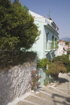 Pythagorio.  Flight of stone steps down to harbour with holiday rental houses on narrow leafy lane.North Eastern AegeanGreek IslandsPithagorion Pythagorioncoast coastalseaSummerpackageholiday...