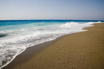 White surf breaking on empty  sandy beach with clear blue sky above.  AegeanGreek IslandsSimicoast coastalseaSummerpackageholidayresortvacationtripdestinationDestinations ElladaEuropean...