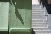 Yialos.  Detail of pale green painted wooden window shutter with flight of steps beyond.  Destination Destinations Ellada European Greek Southern Europe