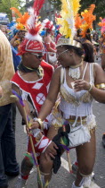 Nottinghill Carnival revellers in colourful costumes.Colorful European Great Britain Holidaymakers Londres Northern Europe Tourism Tourist UK United Kingdom British Isles Sightseeing Tourists