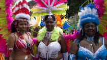 Nottinghill Carnival revellers in colourful costumes.Colorful European Great Britain Holidaymakers Londres Northern Europe Tourism Tourist UK United Kingdom British Isles Sightseeing Tourists