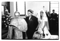 Traditional Greek Wedding ceremony. Bridge and Groom being lead away by Priest still reading from the bible.Classic Classical European Marriage Religion Religion Religious Christianity Christians Mar...